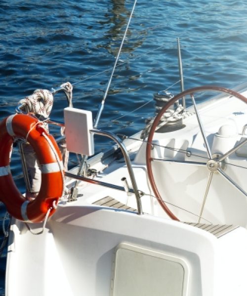 Closeup of Beautiful Yacht Rudder. Daylight. Horizontal. Sea Background.